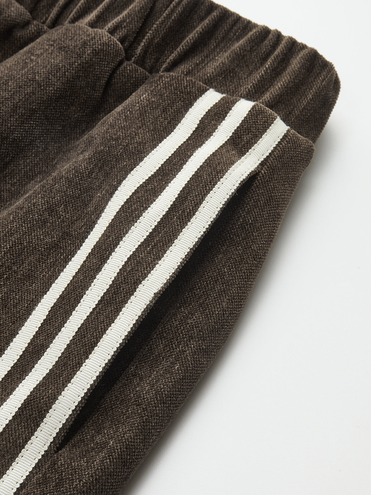 Wide-leg corduroy pants with an elastic waistband and two parallel white side stripes.