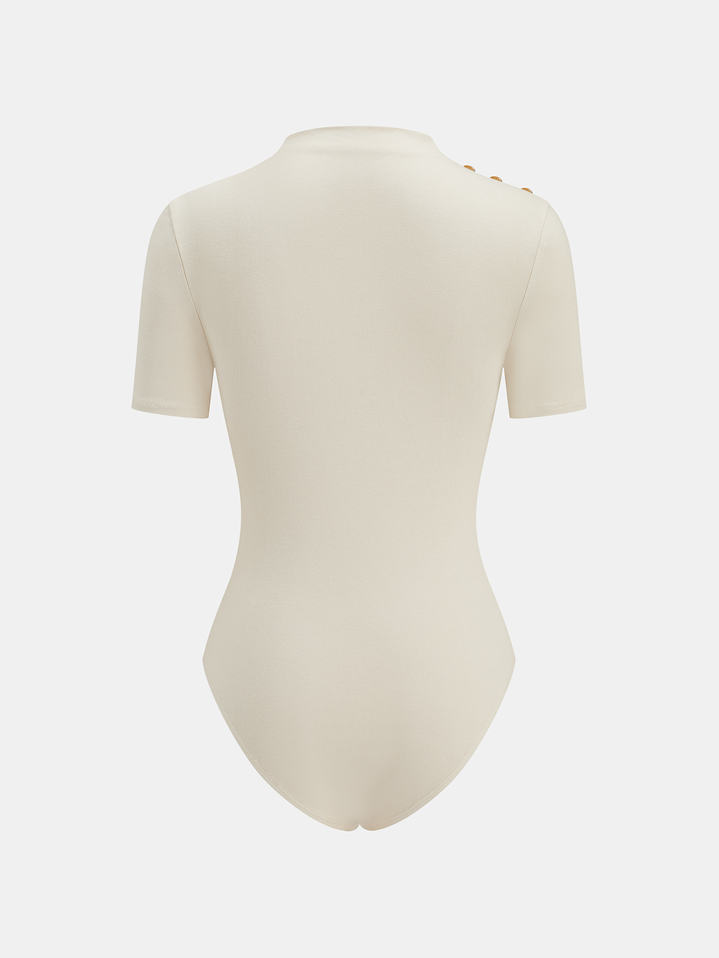 Cream ruched bodysuit with mock neck, metallic accents, short sleeves, and three gold shoulder buttons.