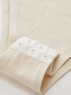 Metallic accent ruched bodysuit with mock neck, textured fabric, and intricate stitching details.