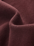 Dark red, ribbed knit mini dress with soft folds and a subtly fuzzy texture.