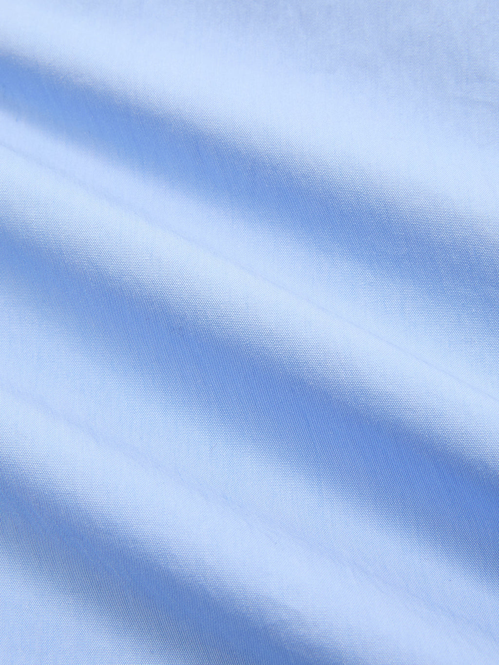 Light blue, sleeveless cotton-blend maxi dress with decorative details and elegant, diagonal folds.
