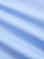 Light blue, sleeveless cotton-blend maxi dress with decorative details and elegant, diagonal folds.