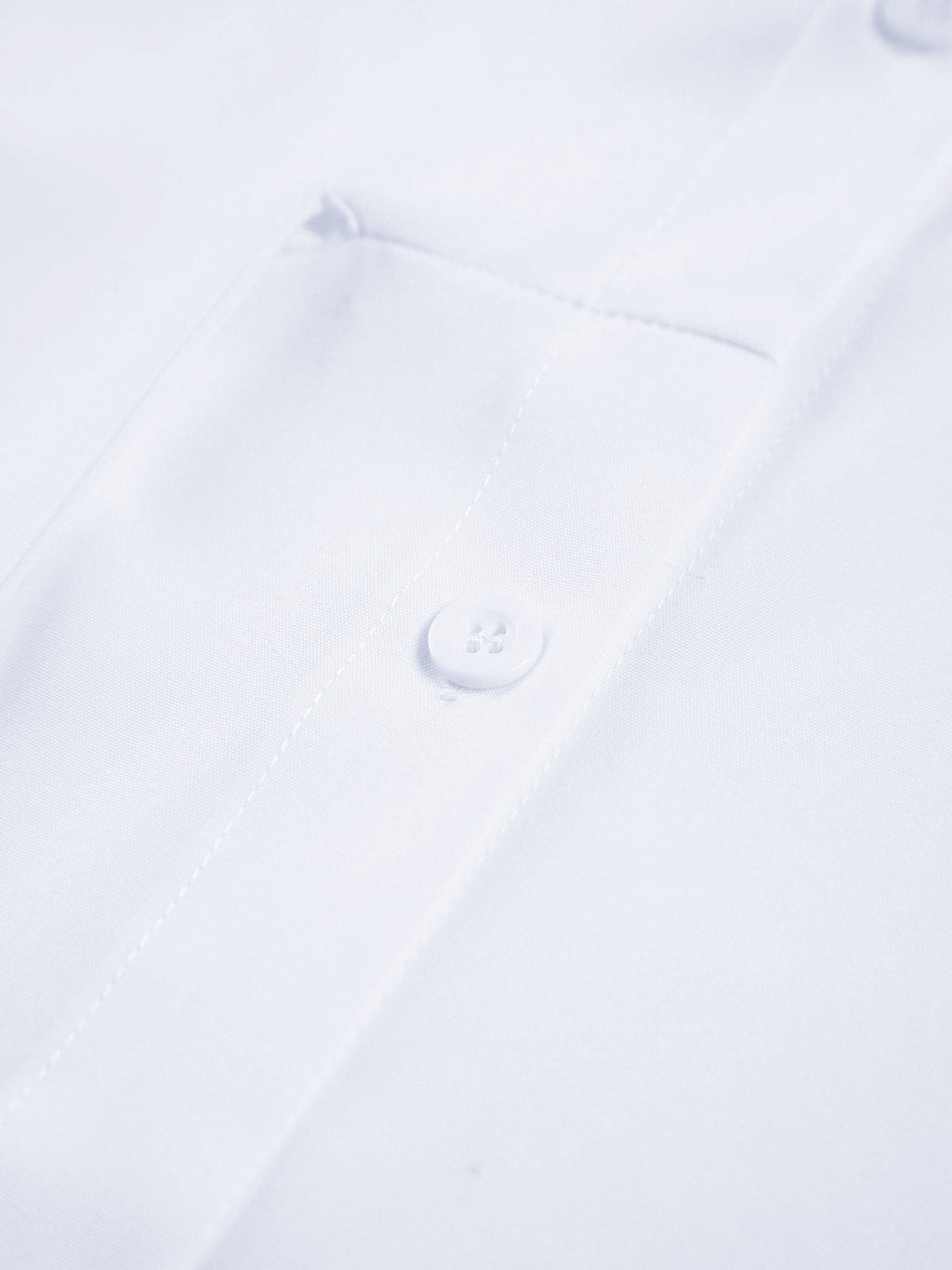 Semi-sheer long shirt with button-down ties, visible button, pocket edge, and neat stitching.