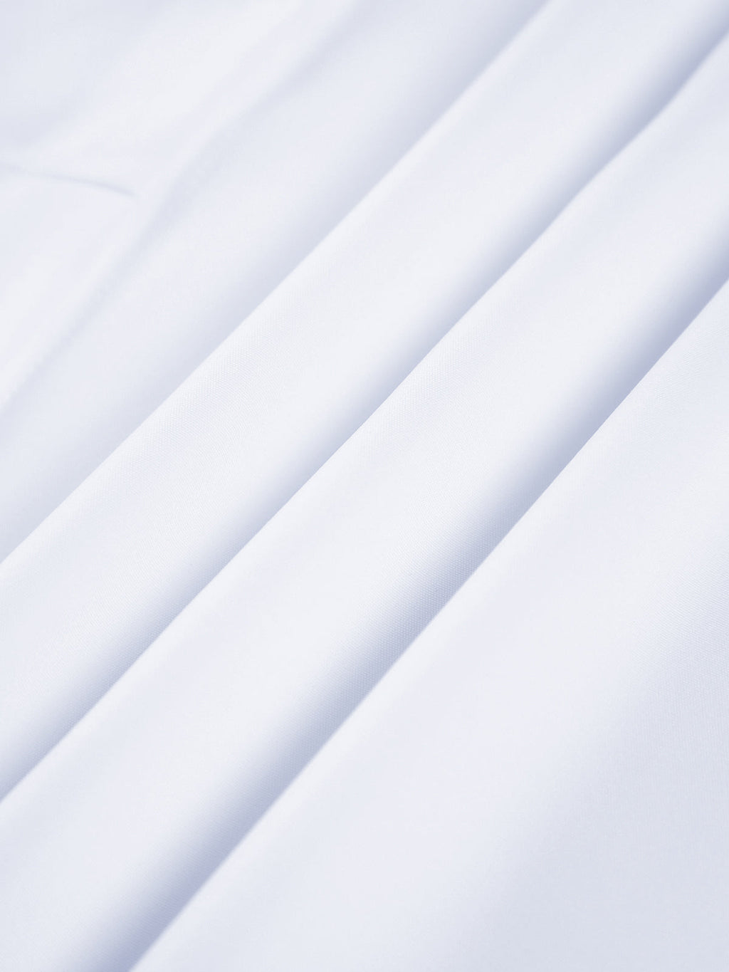 Semi-sheer long shirt with button-down ties, smooth white fabric and soft folds.