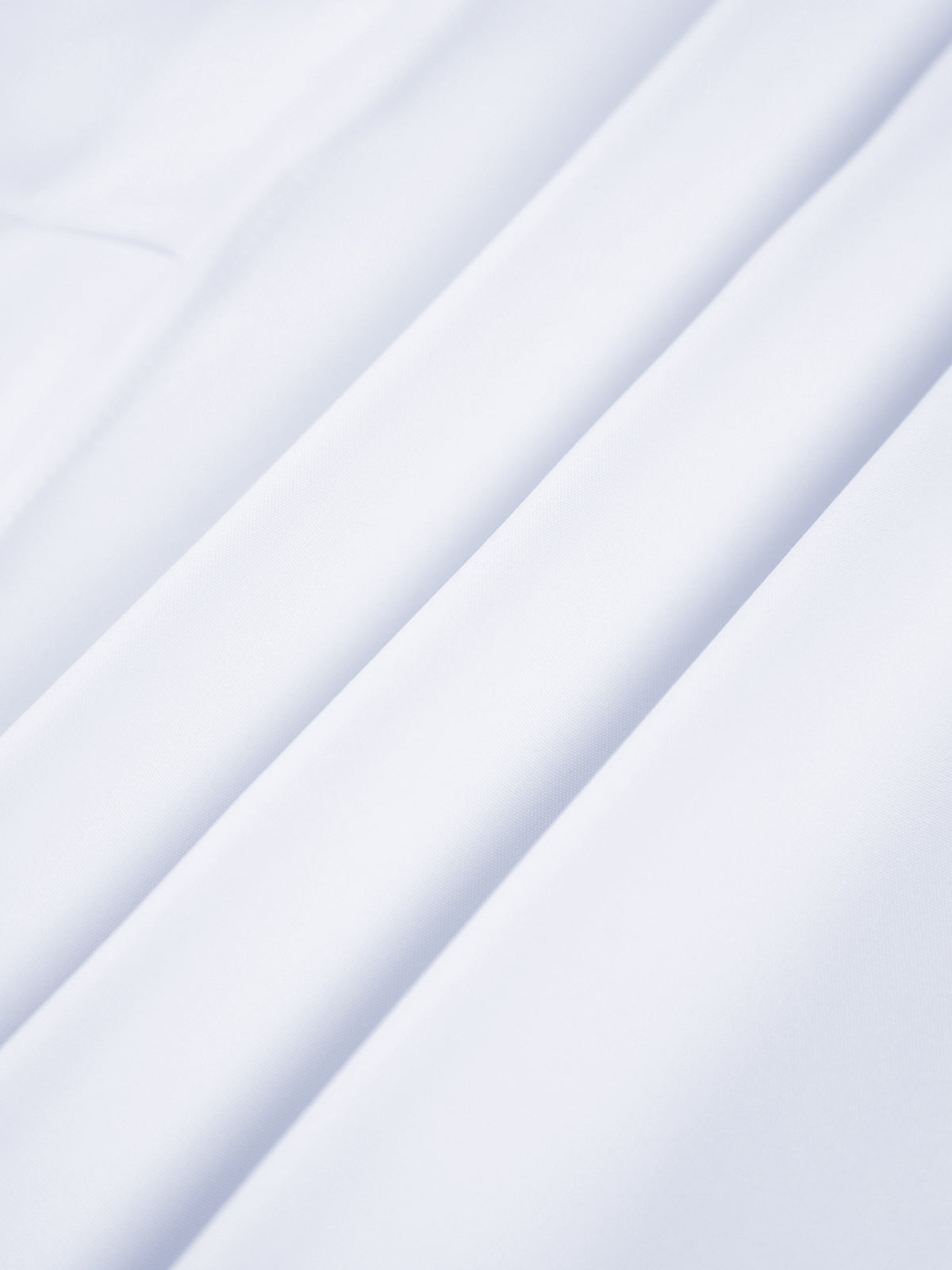 Semi-sheer long shirt with button-down ties, smooth white fabric and soft folds.