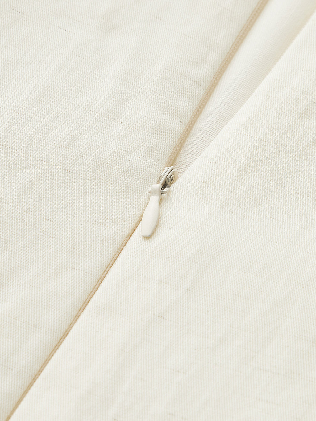Sleeveless Tencel blend mini dress with fine vertical texture, asymmetric buckle, and ruched detailing.