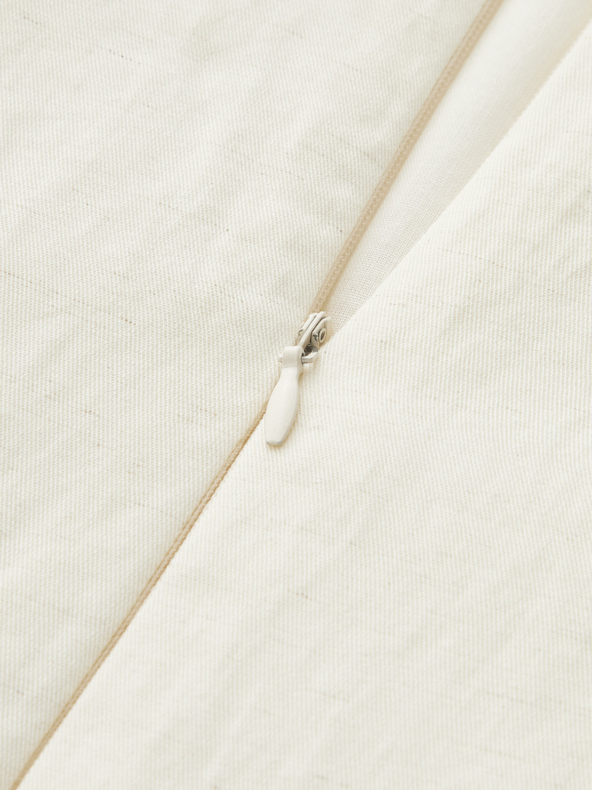 Sleeveless Tencel blend mini dress with fine vertical texture, asymmetric buckle, and ruched detailing.