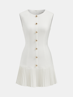 Sleeveless pleated mini dress with fitted bodice, gold buttons, round neckline, concealed zipper.