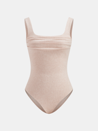 Light beige bodysuit with wide straps, square neckline, and ruched ribbed slim-fit fabric.