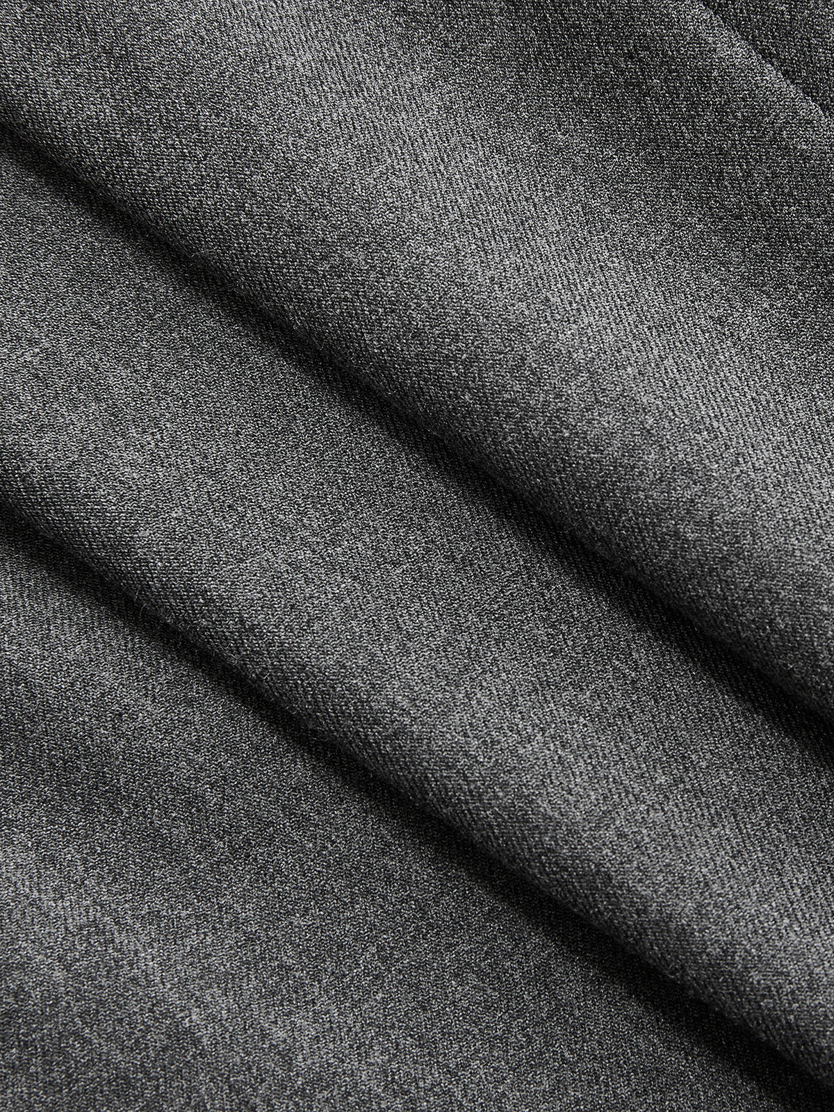 Soft grey sleeveless belted blazer dress, pleated details, subtle diagonal lines, refined woven texture.