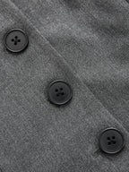 Sleeveless belted blazer dress with pleated details, gray fabric, and three black buttons.