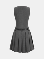 Gray sleeveless blazer dress with black belt, fitted waist, pleated skirt, knee-length.