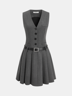 A grey sleeveless blazer dress with black belt, pleated skirt, chest pocket, and buttons.