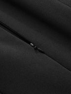 Black zipper detail with metal pull on textured fabric, part of a flared hem dress.