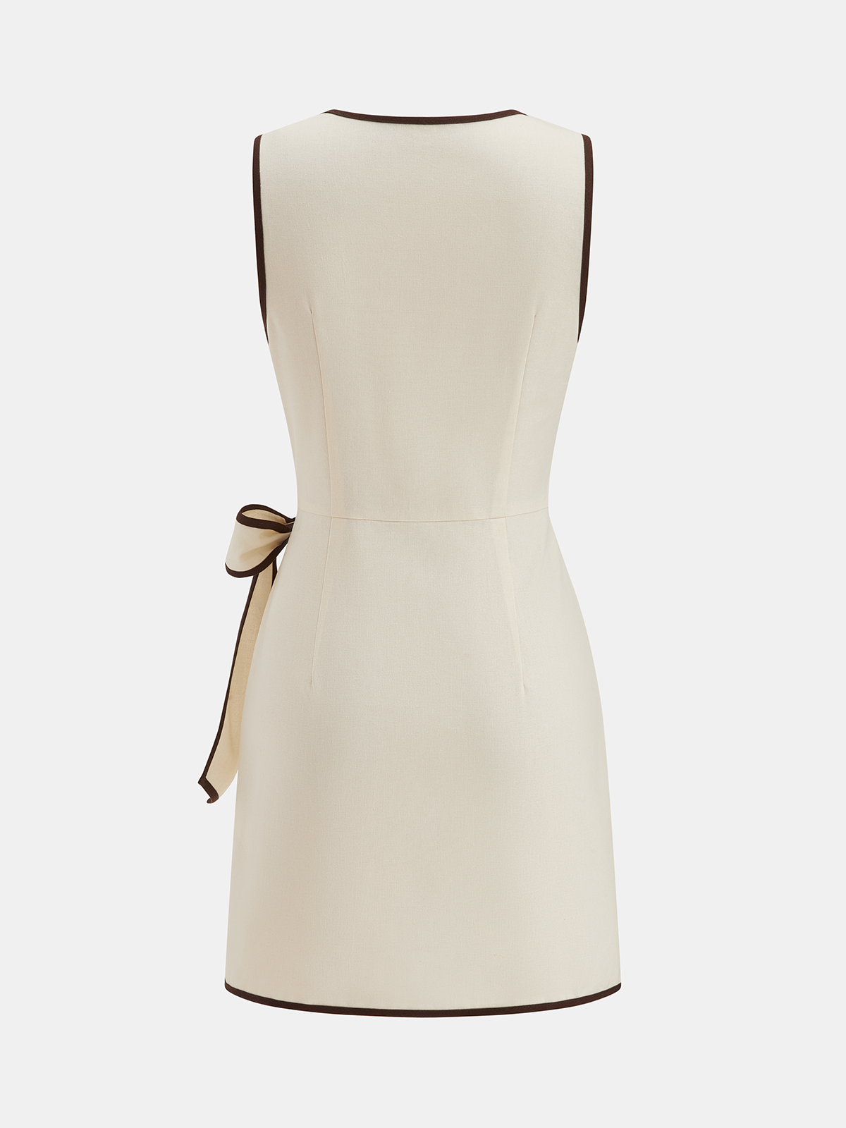 Sleeveless cream mini dress with dark brown trim and a matching waist bow.