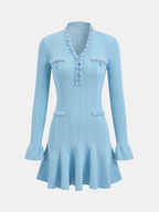 Light blue ribbed knit mini dress with pearl trim, ruffled hem, pockets, and long sleeves.