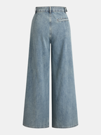 Ruched wide-leg jeans in light wash with high waist, asymmetrical cut, and single back pocket.