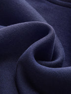 Striped off-shoulder deep blue sweatshirt with cuffs, soft cotton-rich fabric, gently folded.