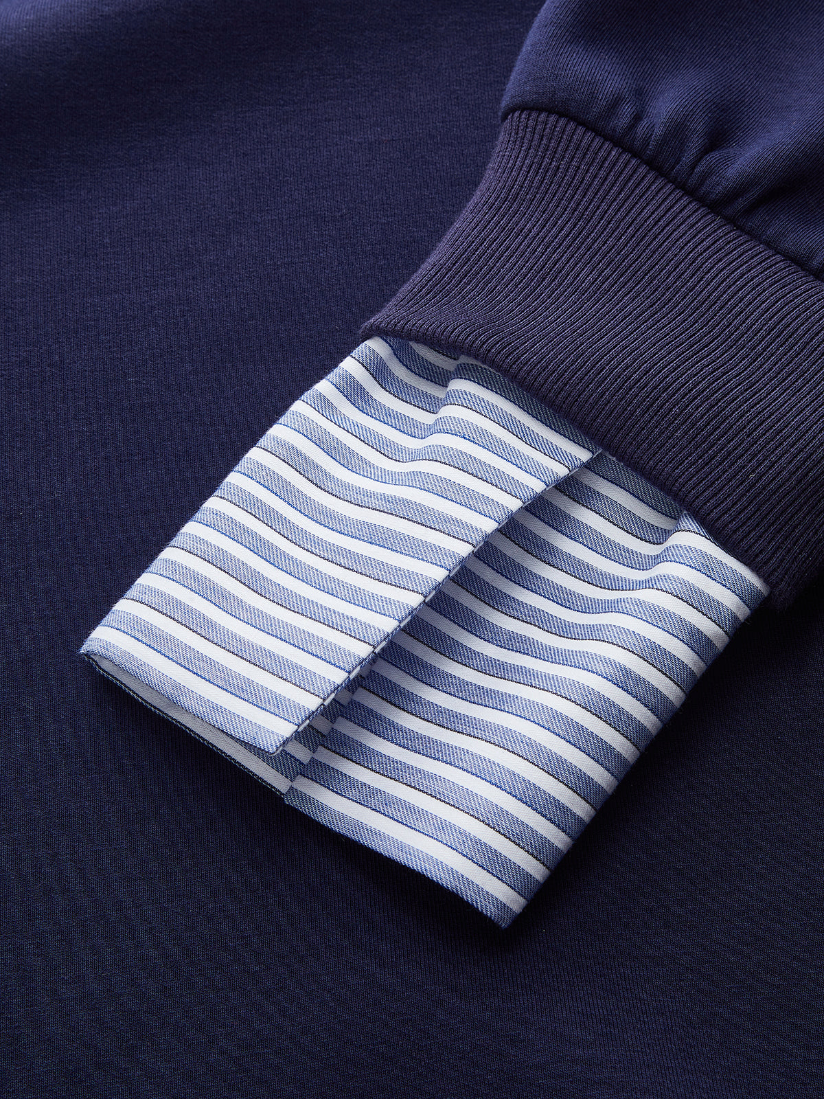 Navy blue cotton-rich off-shoulder sweatshirt with ribbed cuff and striped shirt cuff detail.