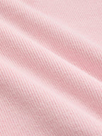 Short sleeve cardigan made of soft, light pink ribbed fabric with gentle folds and lace trim.
