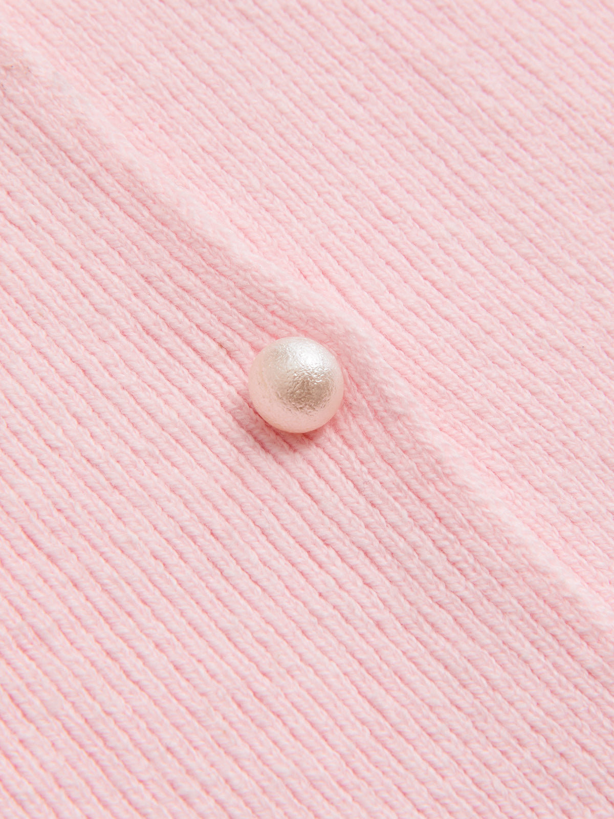 Light pink ribbed cardigan with lace trim, round pearl button, and visible vertical texture.