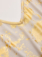 Light beige slip dress with shiny gold foil splatters and a precisely stitched V-neckline.