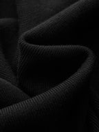 Black ribbed knit maxi dress with cap sleeves, finely textured and softly curved folds.