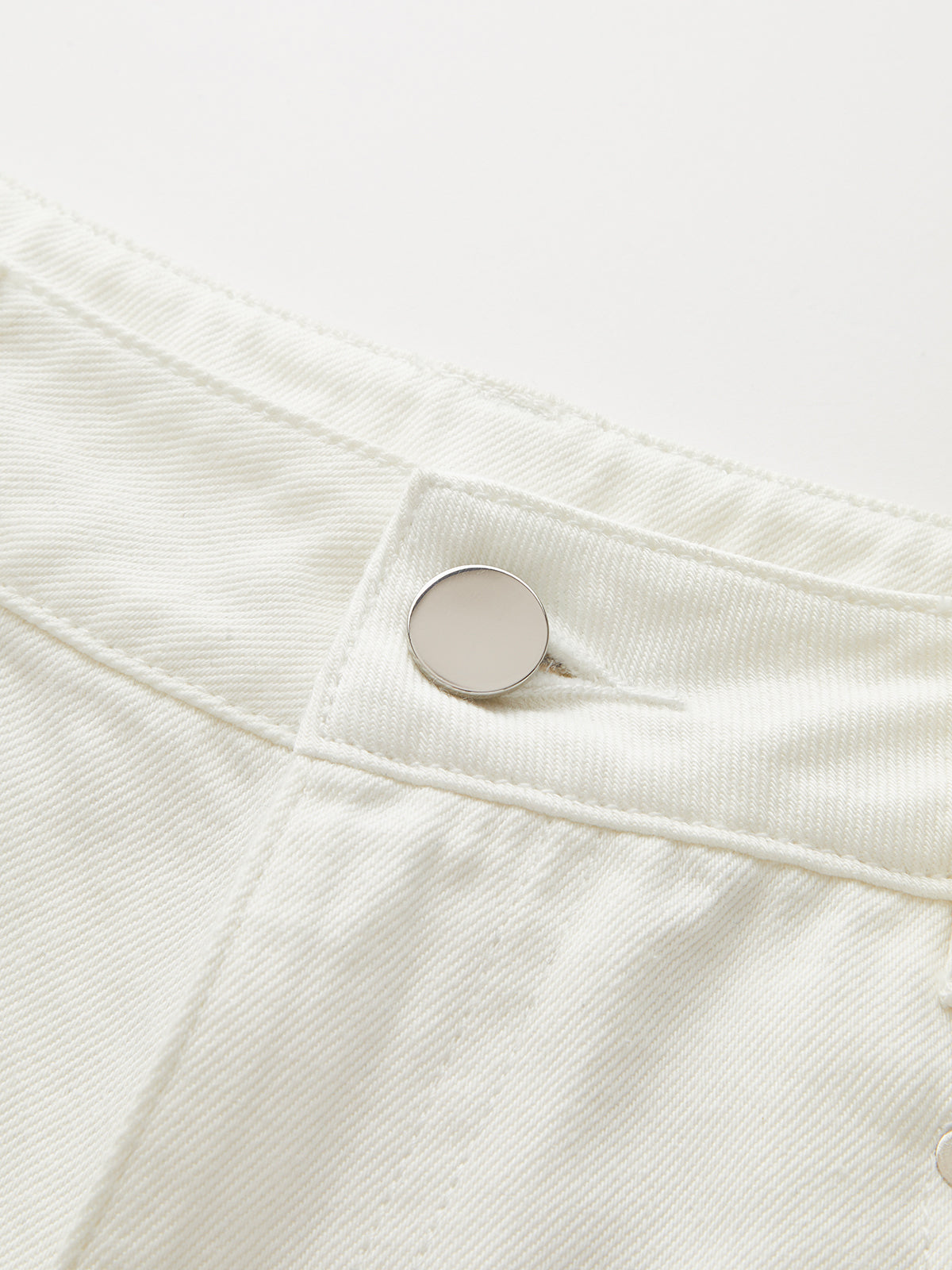 Mid-rise wide-leg jeans with soft denim, metal button, visible stitching, and Tencel cotton blend.