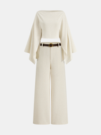 A cream linen crop top with bold sleeves, paired with matching high-waisted wide-leg pants.