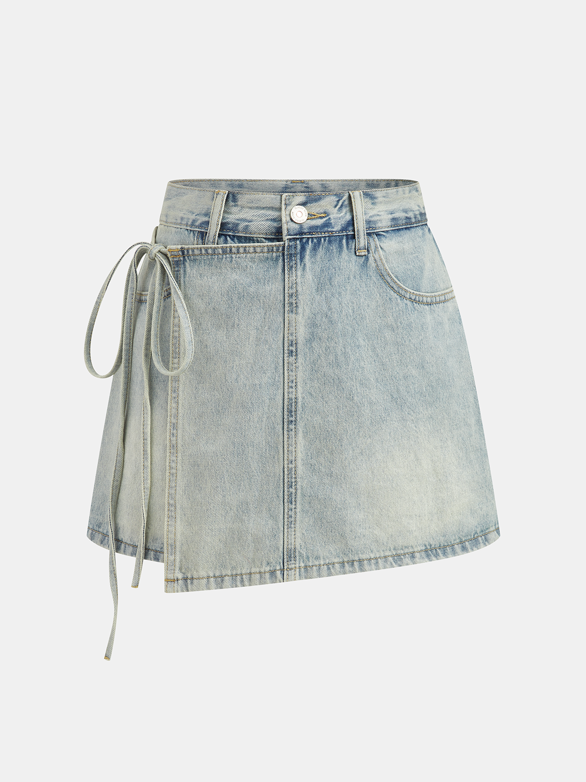 A denim mini skort with crossover front, side tie, asymmetric hem, faded wash, gold stitching.