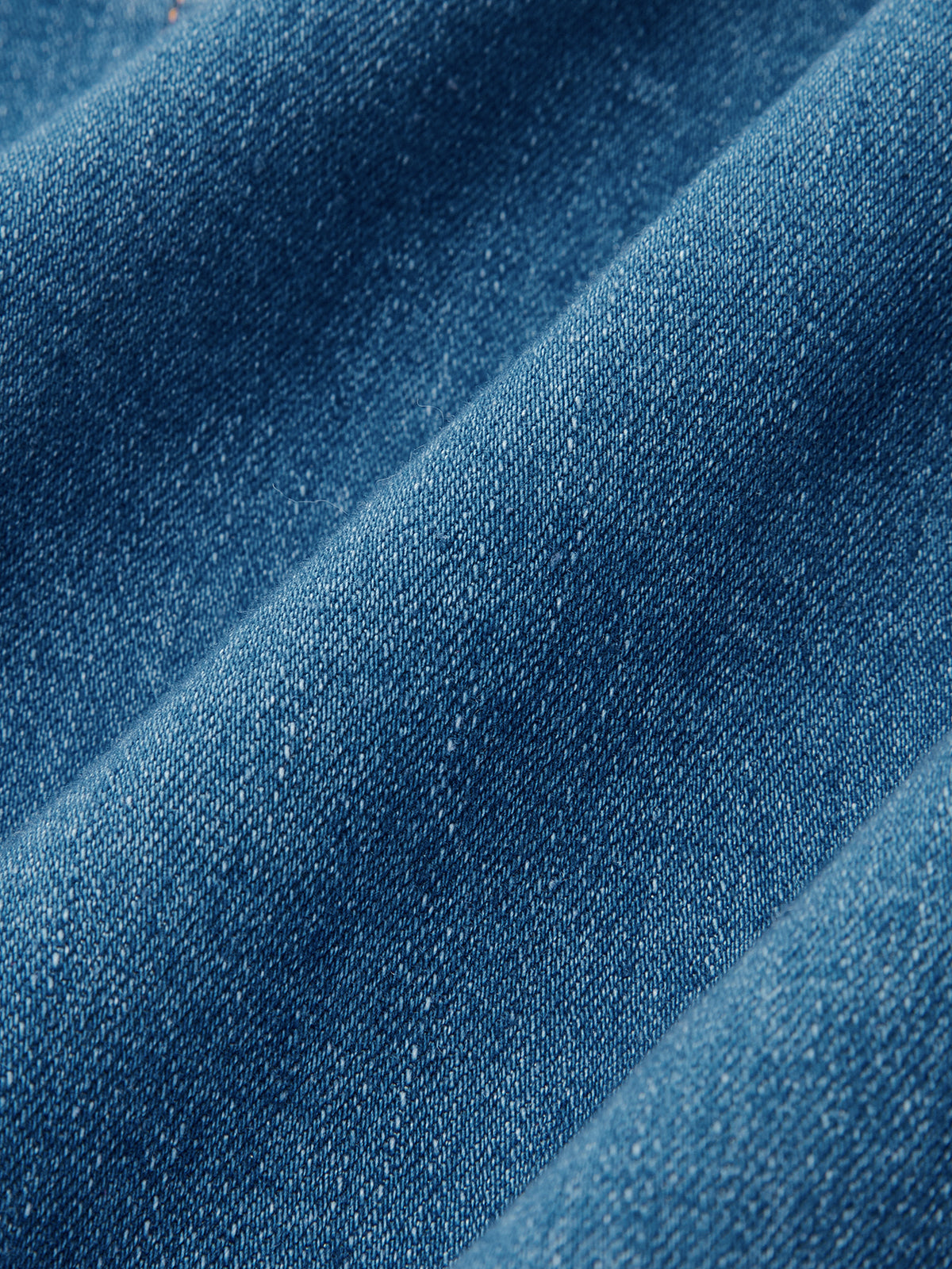 Blue denim halter dress with button-front and maxi design, detailed weave, soft shadows.