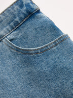 LA FINE FLEUR asymmetric high-rise straight leg jeans with front pocket and brown stitching.
