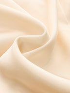Light beige satin midi dress with ruched split detail, smooth texture and subtle sheen.