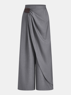 Gray high-waisted trousers with wrap-style wide legs and a brown buckle accent.