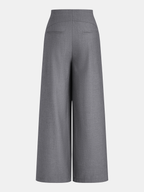 Back view of wrap-style wide-leg trousers with buckles, slit pockets, and tailored chic design.