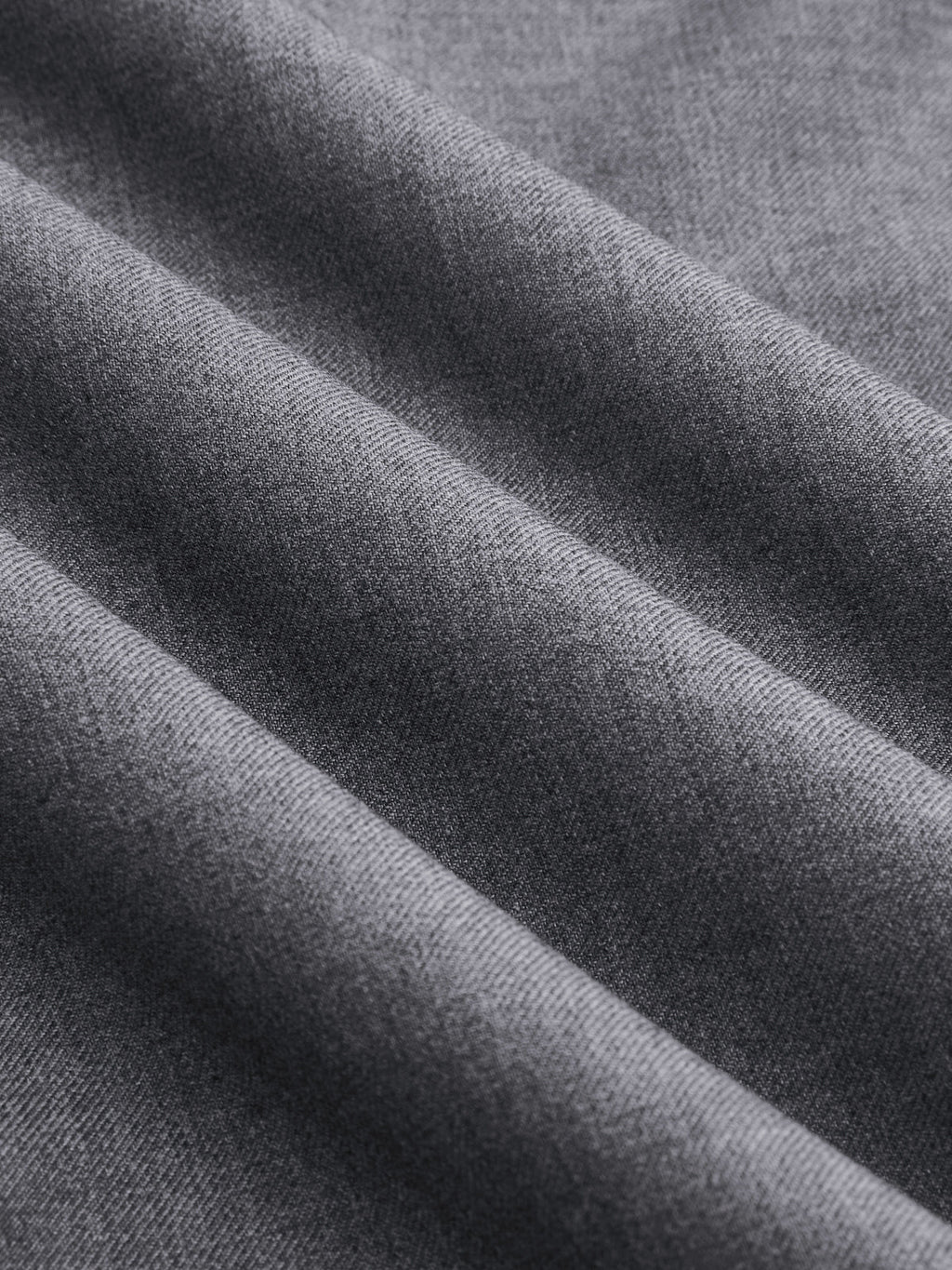 Soft gray wrap-style wide-leg trousers with fine weave and diagonal folds, featuring buckle accents.