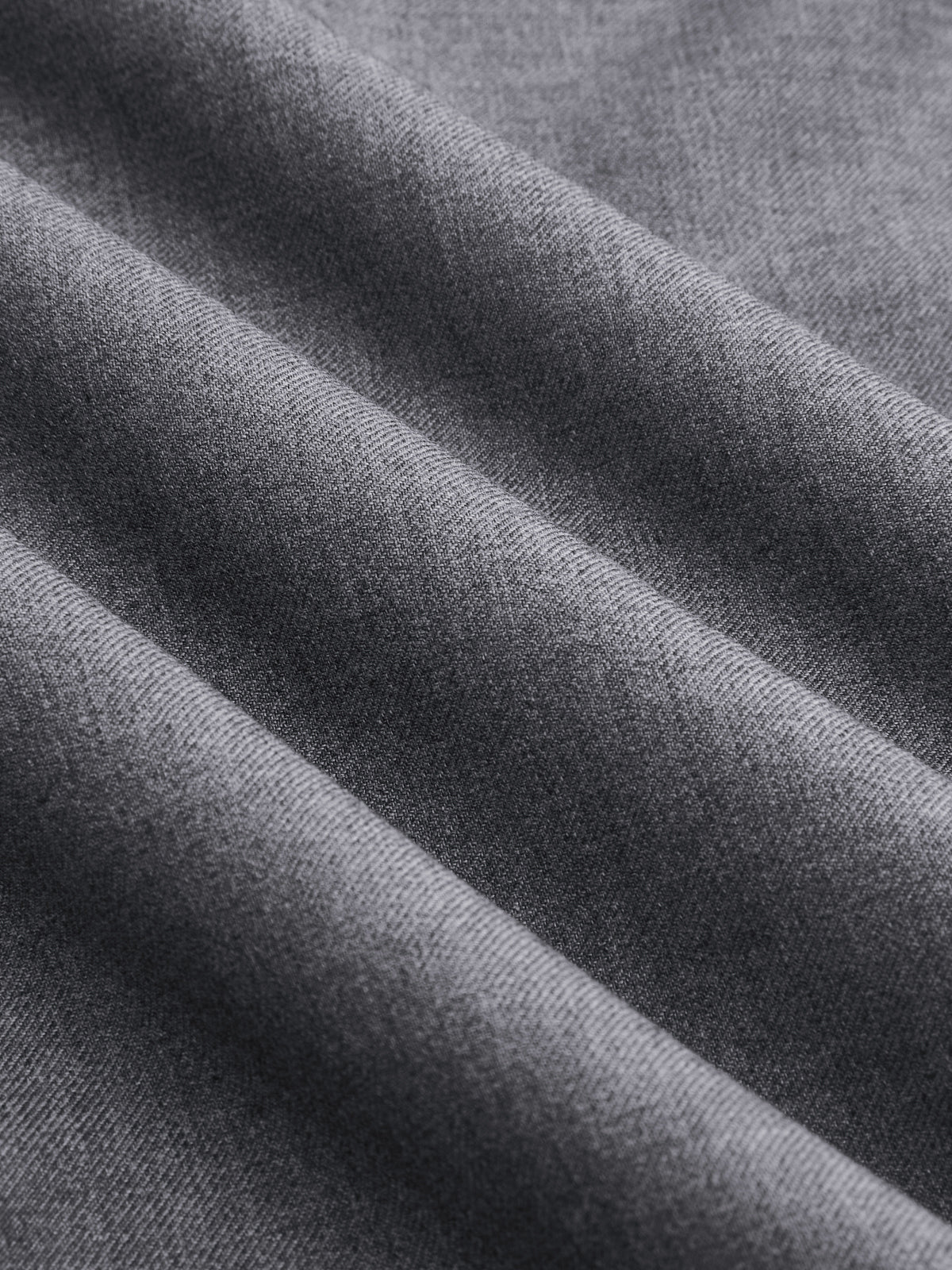Soft gray wrap-style wide-leg trousers with fine weave and diagonal folds, featuring buckle accents.