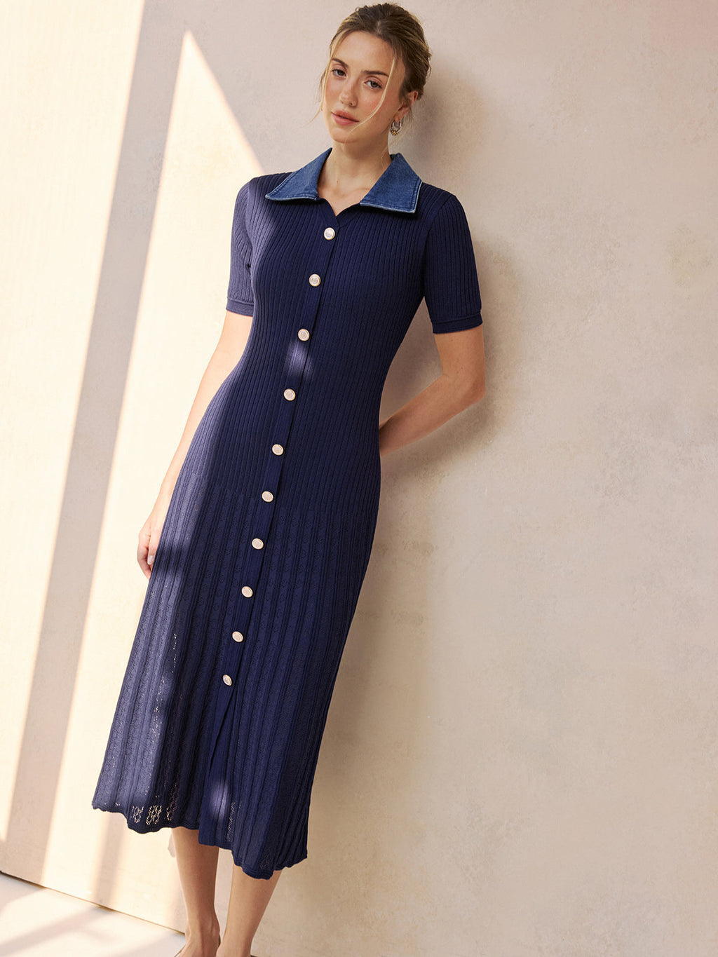 A short-sleeve, navy, ribbed midi knit dress with a denim collar and buttons.