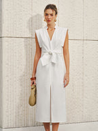 A cotton-linen V-neck sleeveless dress featuring a bow split detail.