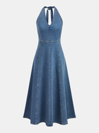 Sleeveless denim midi dress with halter tie neckline, fitted bodice, flared skirt, vertical seams.
