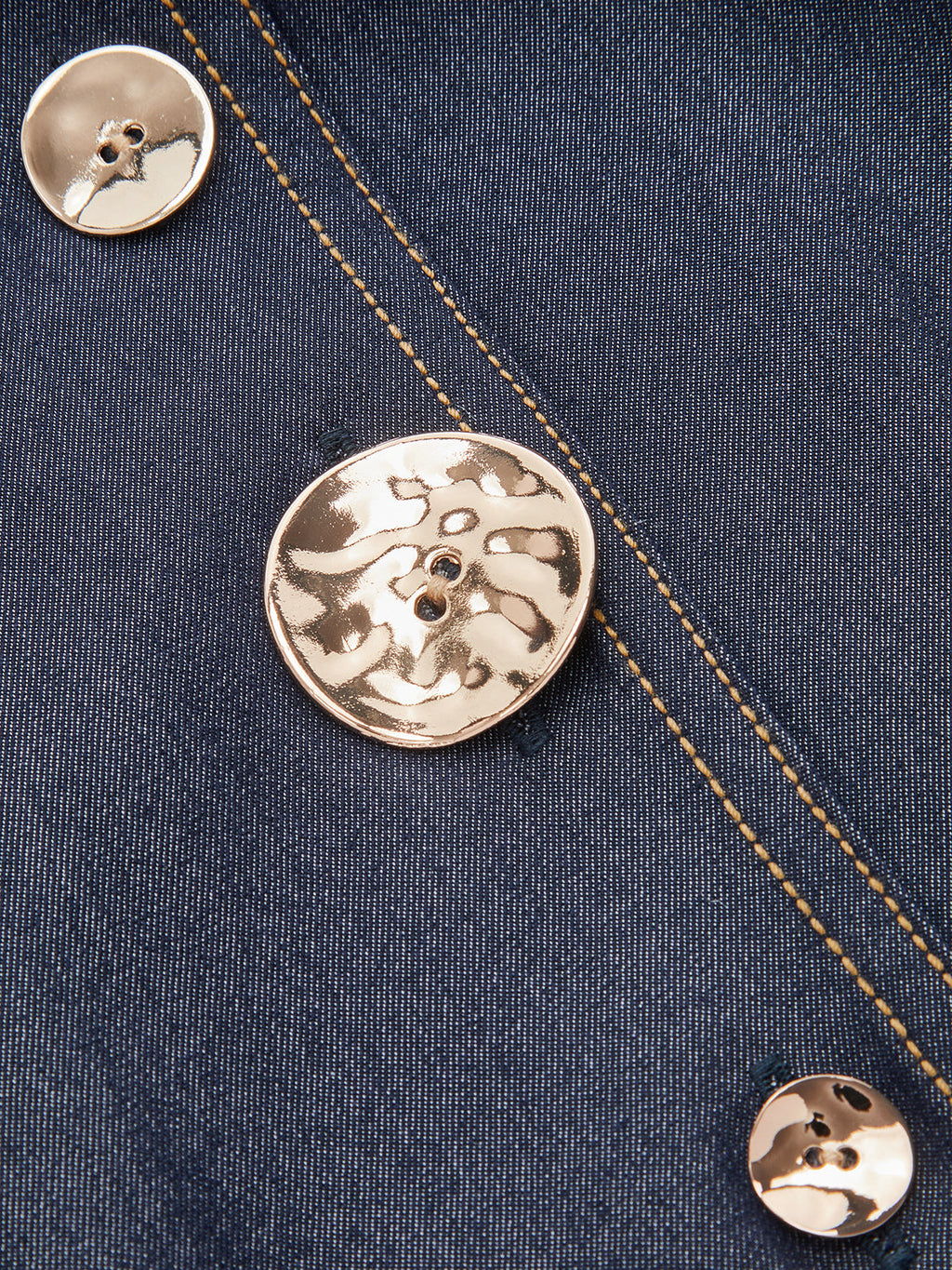Dark blue denim maxi dress with v-neckline, gold buttons, and yellow contrast stitching.
