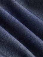 Dark blue sleeveless belted denim maxi dress with button details, diagonal folds, subtle sheen.