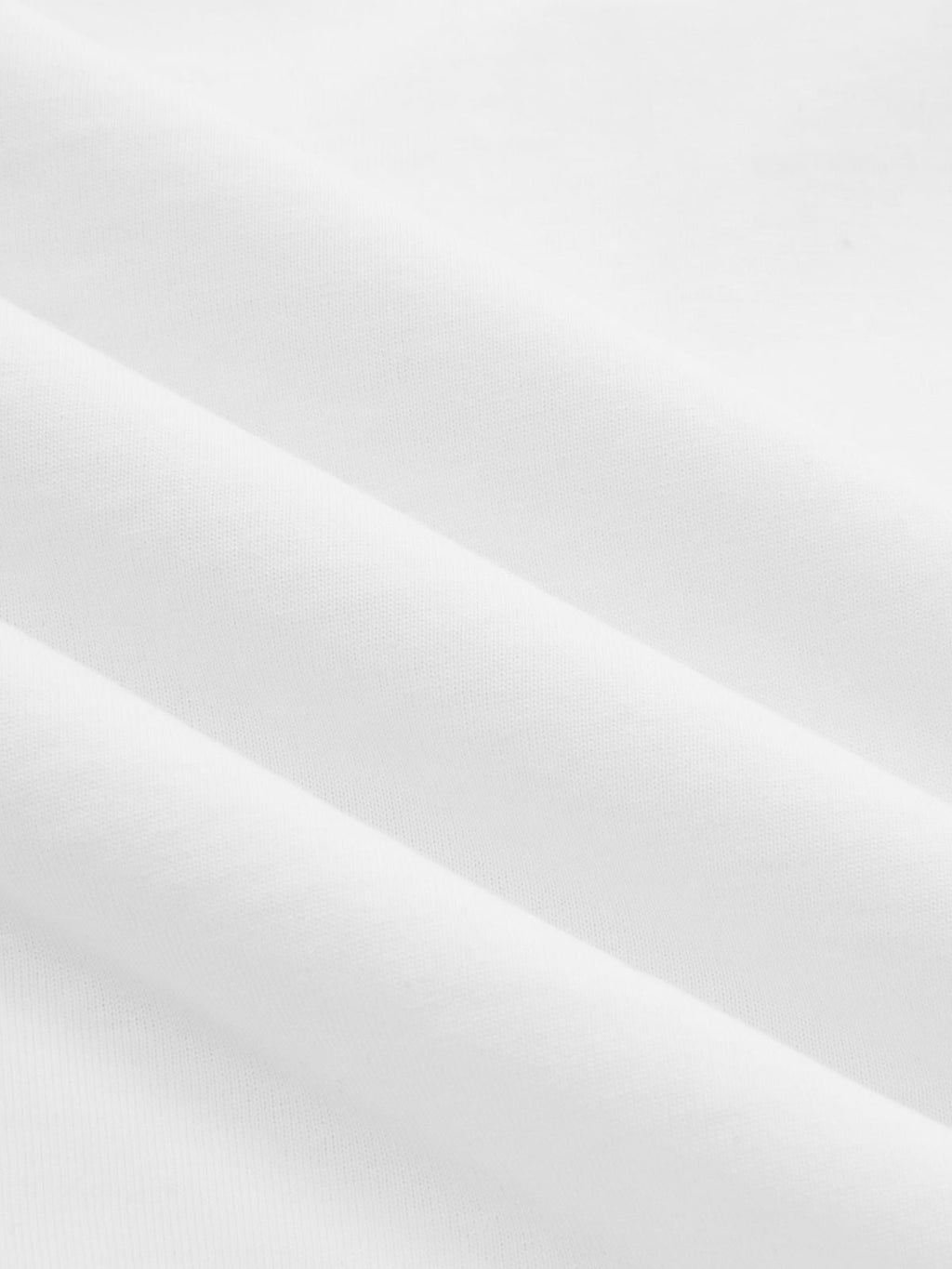 White cotton crop top with knotted sleeves, smooth jersey and soft diagonal folds.
