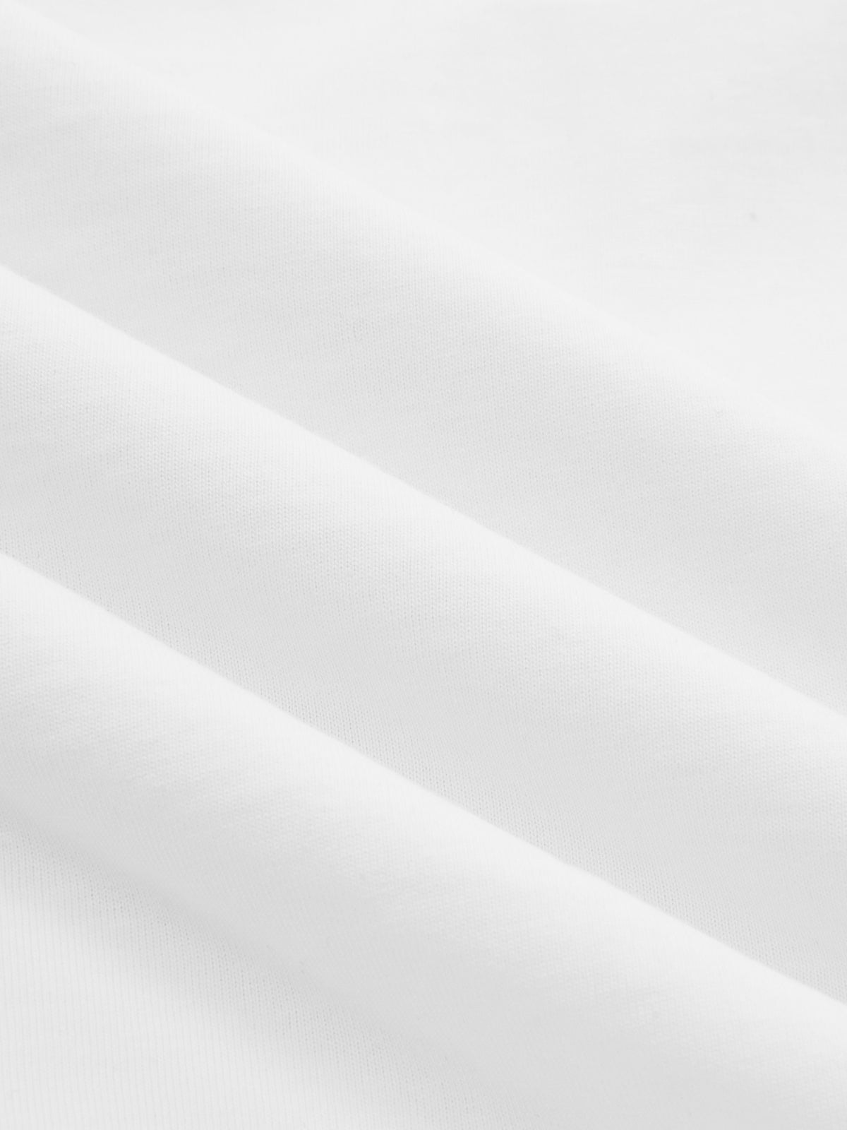 White cotton crop top with knotted sleeves, smooth jersey and soft diagonal folds.