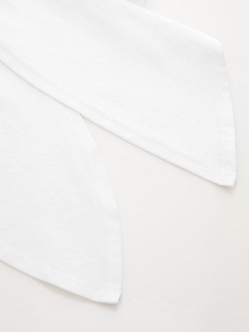 Two white cotton Knotted Sleeve Crop Tops with pointed ends, featuring a minimalist design.