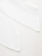 Two white cotton Knotted Sleeve Crop Tops with pointed ends, featuring a minimalist design.
