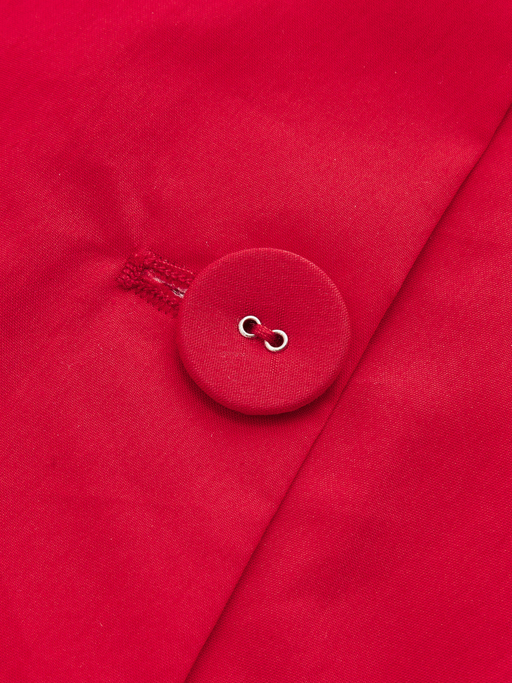 Close-up of detailed stitching and round red button on LA FINE FLEUR maxi dress.