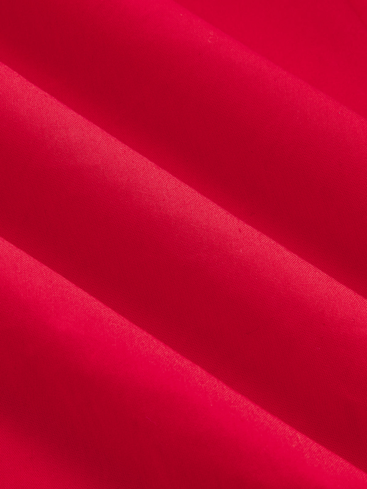Close-up of a cotton blend maxi dress, bright red with button-front, soft folds, textured fabric.