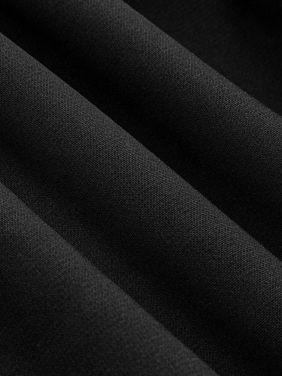 Close-up of the LA FINE FLEUR Mandarin Collar Dress, showing its textured black fabric folds.