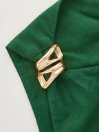 One-shoulder linen blend mini dress with ruching, secured by a shiny gold brooch.